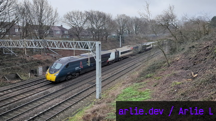 AWC Class 390 passing Madeley Foot Bridge