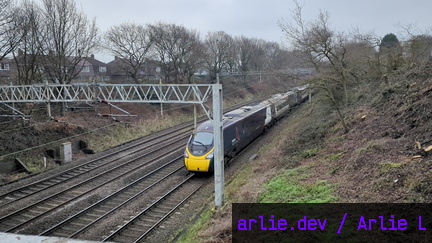 AWC Class 390 passing Madeley Foot Bridge