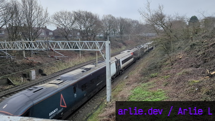 AWC Class 390 passing Madeley Foot Bridge